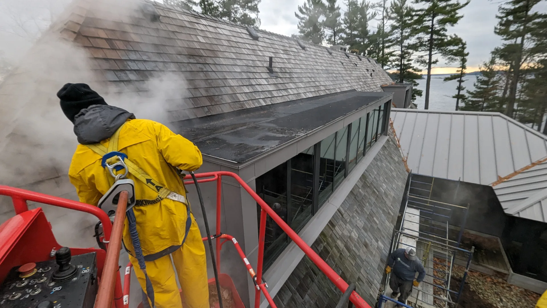 Aerial lift roof treatment on a Muskoka home
