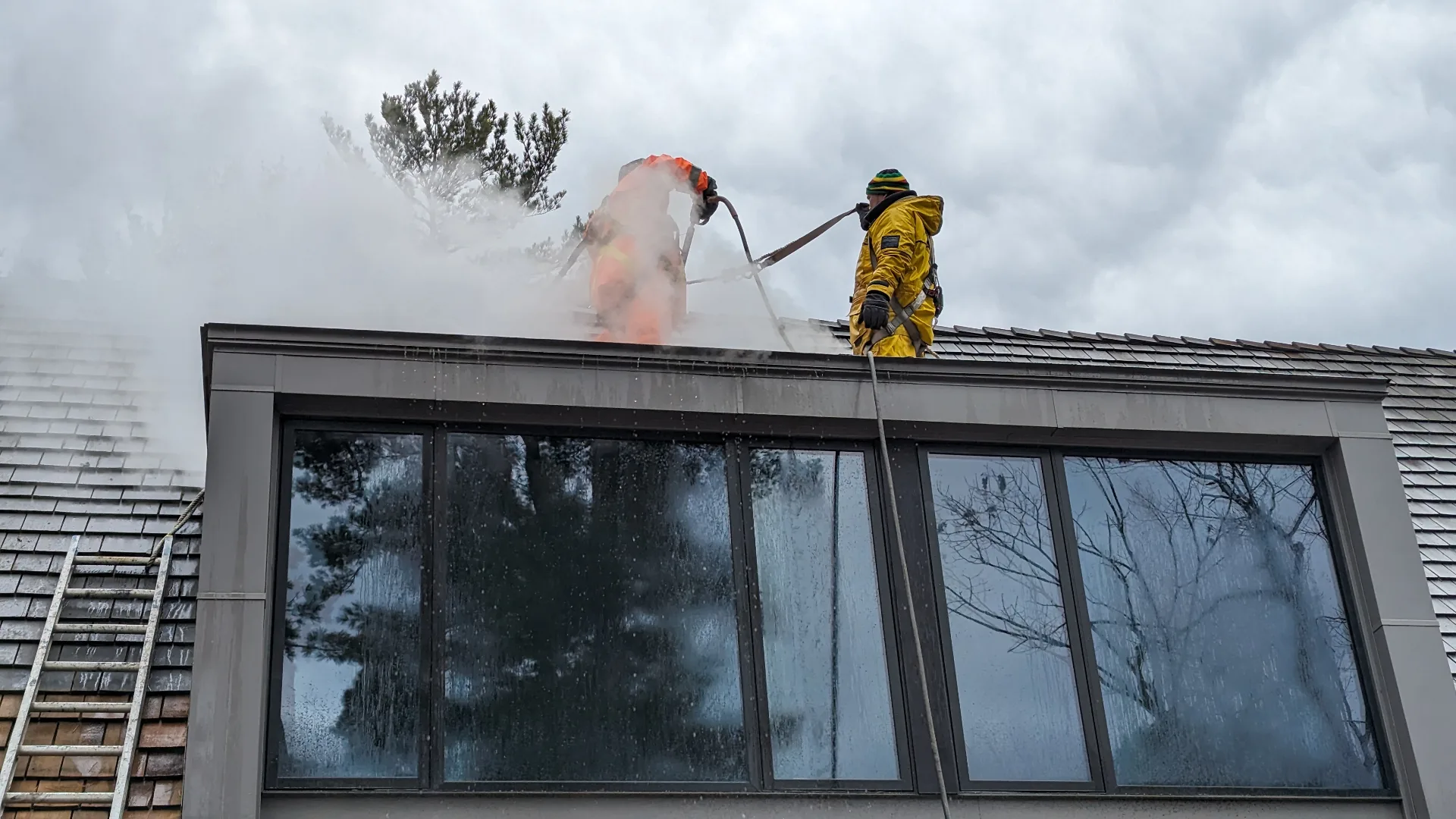 Roll On Painting team performing roof soft wash in Muskoka